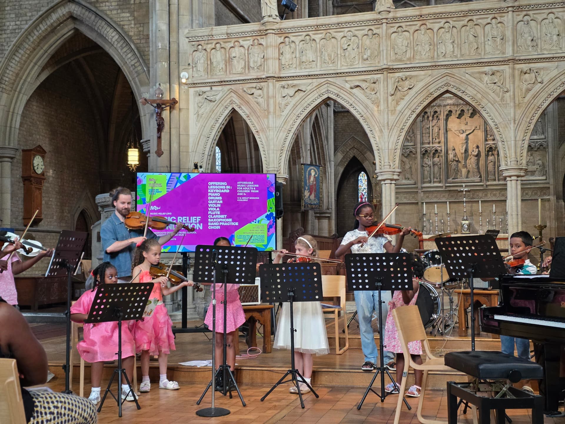 Children's violin ensemble performing at the Summer Soirée