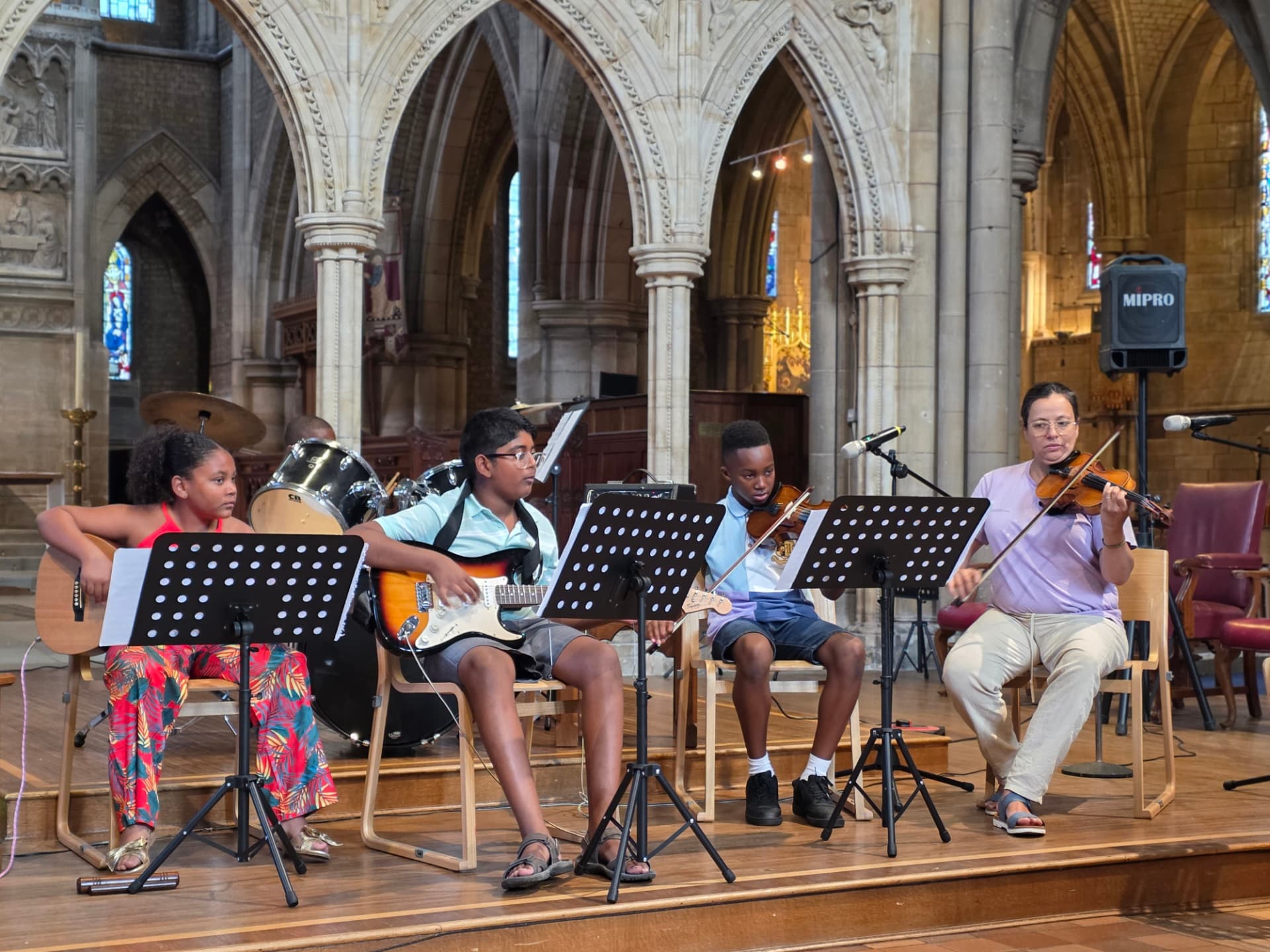 Students watching a Music Relief Foundation film at the Summer Soirée