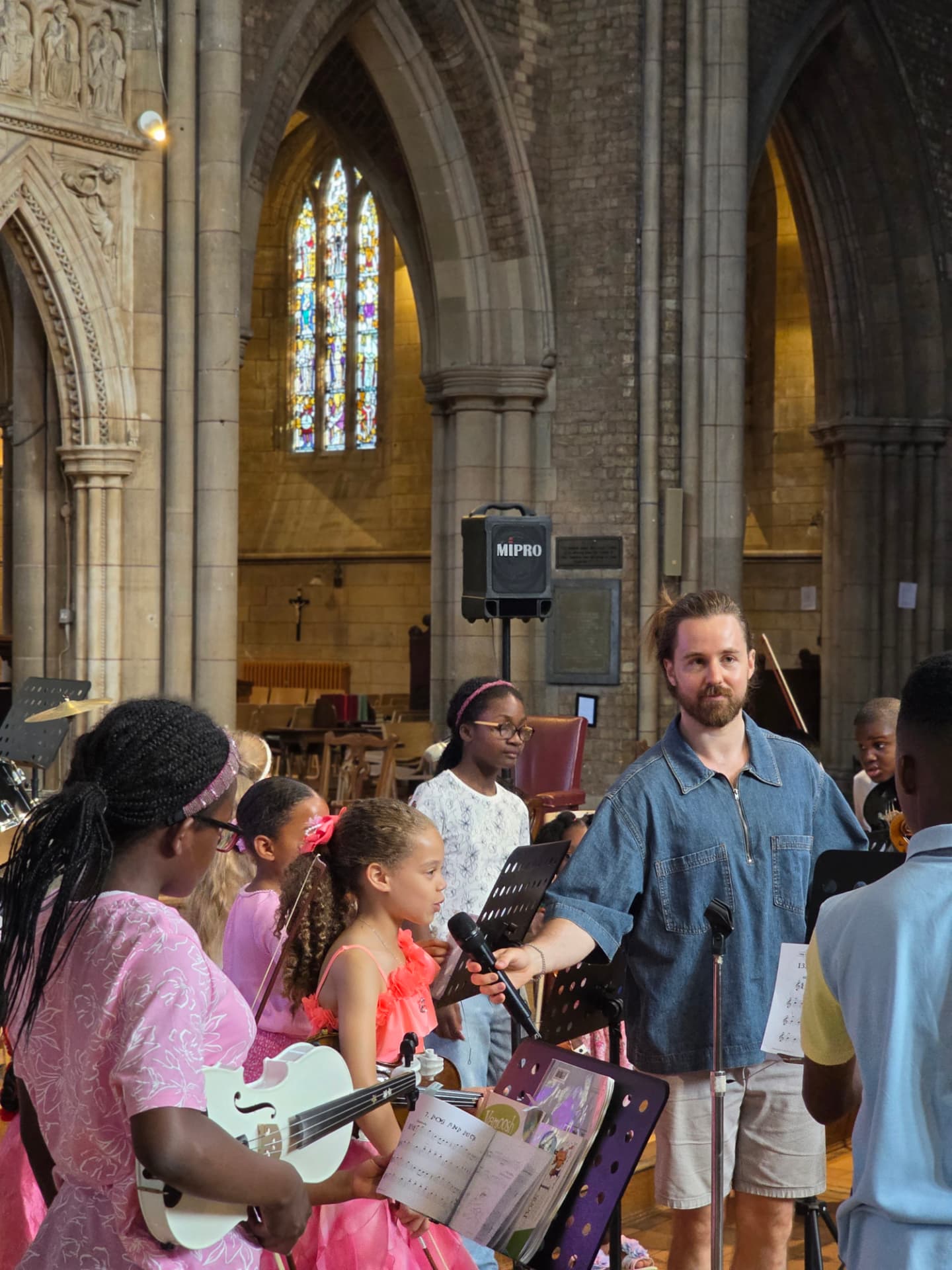 A tutor interviewing a young violinist at the Summer Soirée