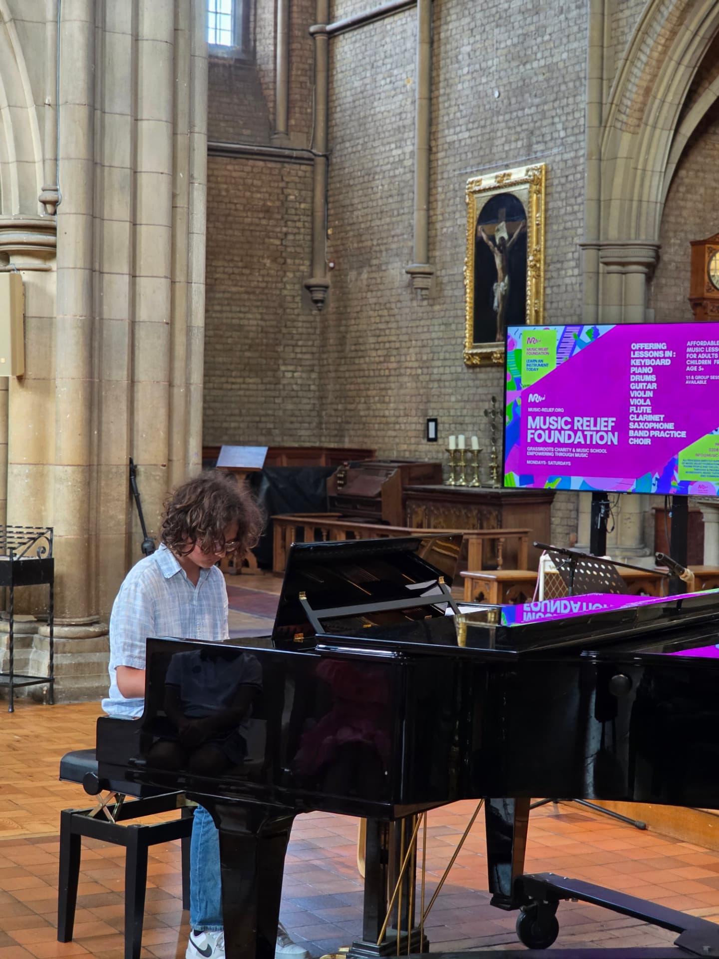 A student performing on grand piano at the Summer Soirée